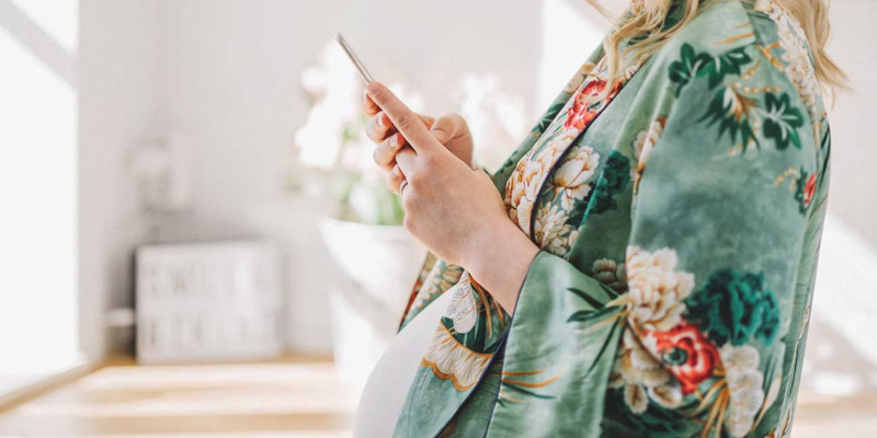 Pregnant Woman Looking at Cell Phone