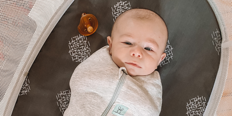 Baby resting in bassinet