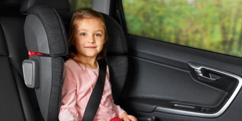 Little girl sitting in an UPPAbaby ALTA booster seat in car