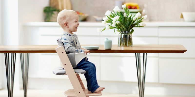 Baby sitting in a Stokke Trip Trap high chair