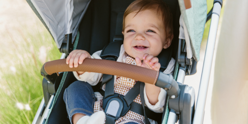 Baby smiling while out for a stroll in the UPPAbaby VISTA V2 Stroller