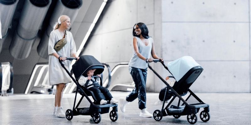 Women pushing babies in Thule Shine strollers