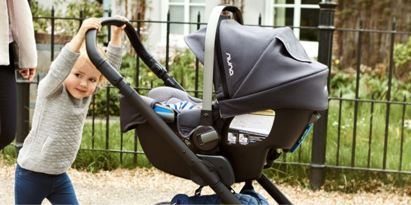 Toddler Pushing Baby in Nuna Infant Seat 