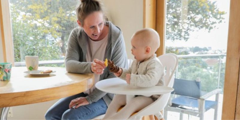 Woman Feeding Baby Sitting in Phil & Teds Poppy V2 High Chair