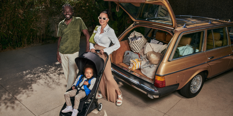 Family standing with toddler sitting in a Bugaboo Butterfly Ultra-Compact Stroller