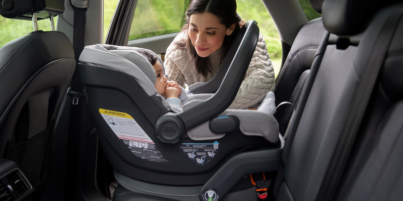Mom checking in on newborn in their UPPAbaby MESA V2 Infant Seat