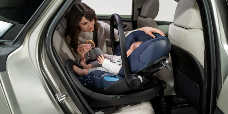 Mom checking on baby in Cybex Cloud G Car Seat