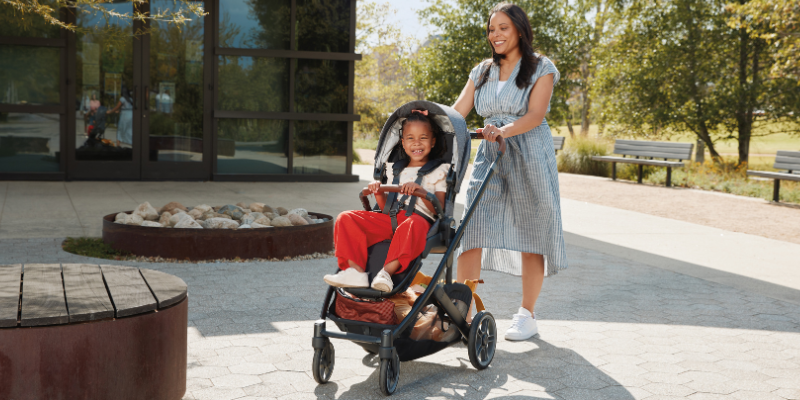 Mom walking with toddler in Cruz V3 Stroller