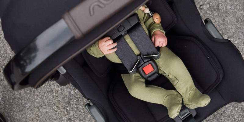 Baby in green sleeper in Nuna PIPA Infant Car Seat
