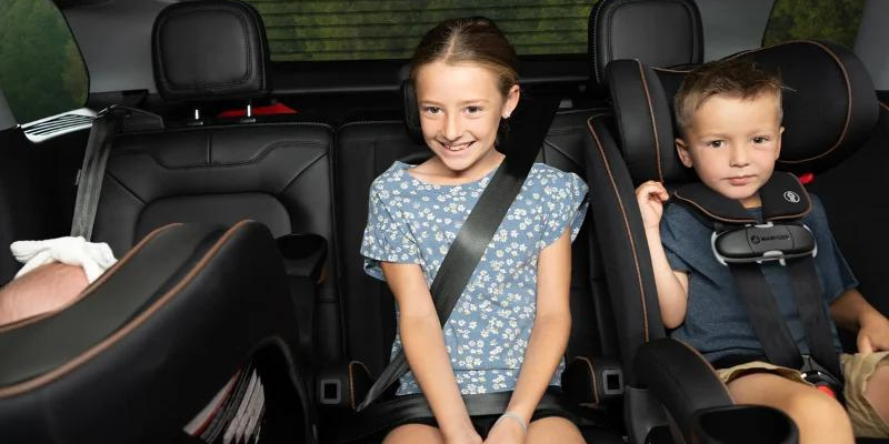 Three kids in the back seat of car in the Kani All-in-One Convertible Car Seat in three different modes