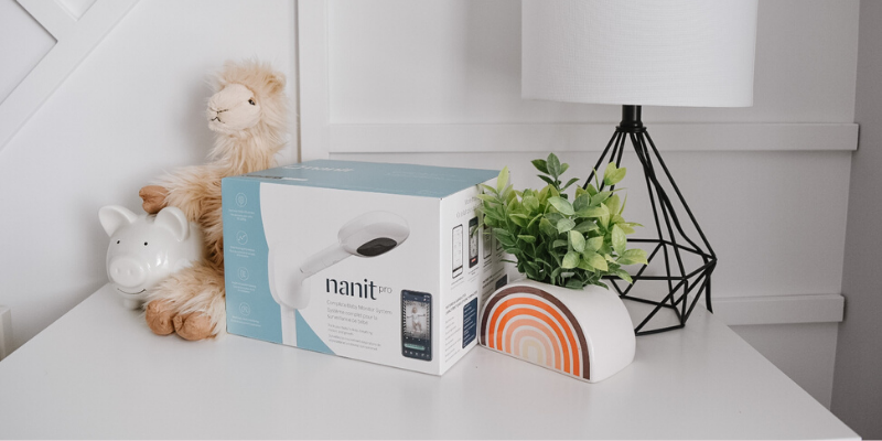 Nanit Pro in Box on Table With Nursery Decor Beside Itt 