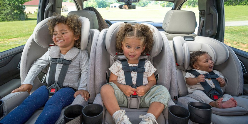 Three children of different ages sitting in Britax One4Life Slim All-in-one convertible car seat