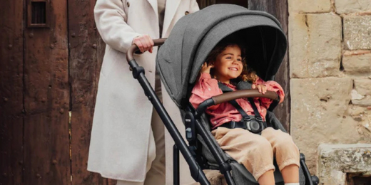 Mom pushing child in Romer Tura Modular Stroller