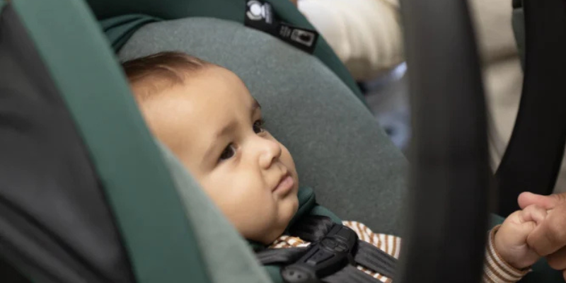 Baby sitting in infant car seat