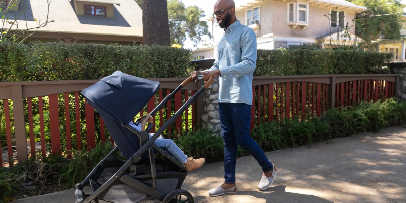 Man pushing baby down street in UPPAbaby Cruz V2