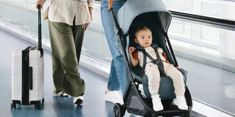 Parent pushing baby in airport in the UPPAbaby Minu V3 Stroller
