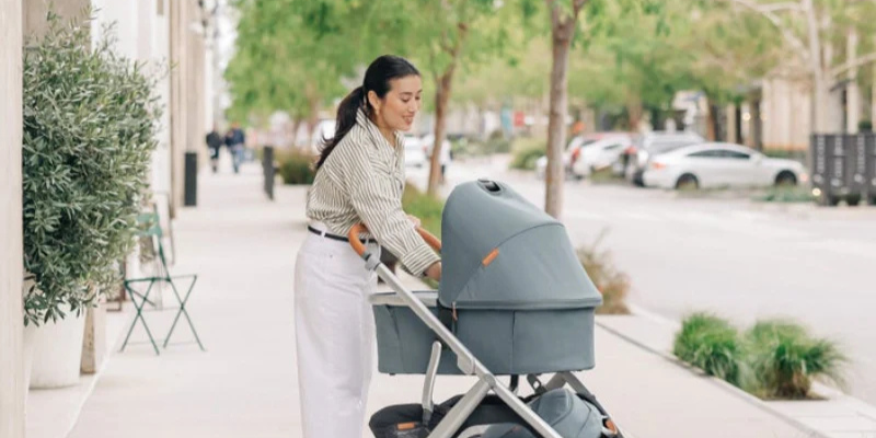 Mother comforting baby in UPPAbaby Vista V3 Bassinet