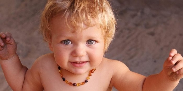 Baby wearing Amber Teething Necklace