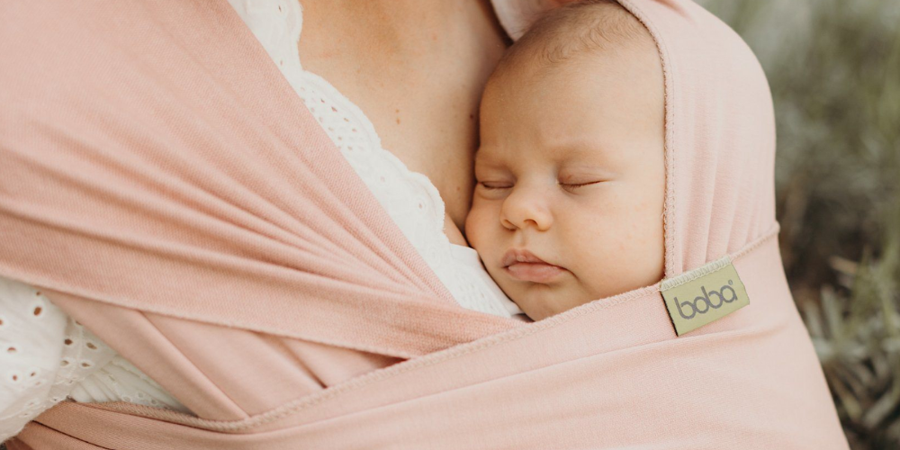 Baby Resting Against Woman Chest in Baby Wrap