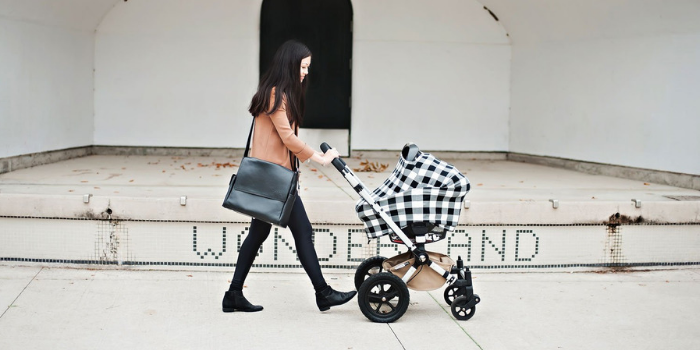 Mom walking with baby in a stroller 