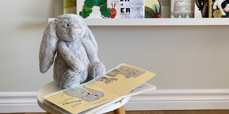 Jellycat bashful bunny in front of open book