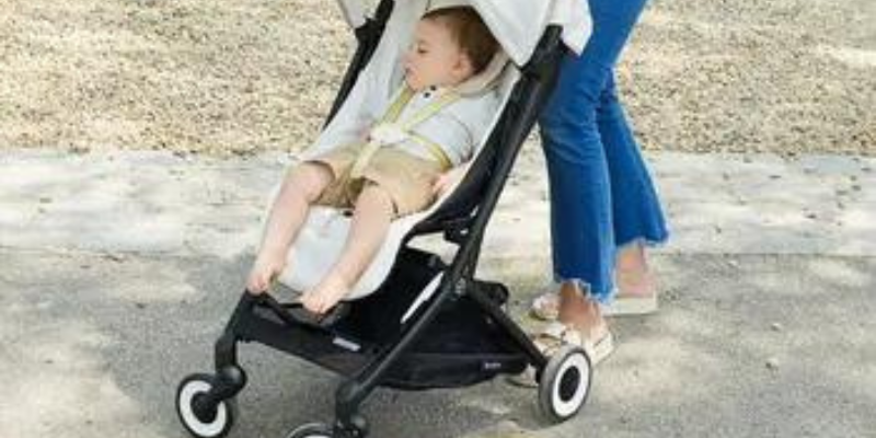 Woman Pushing Cybex Libelle 2 Ultra Compact Stroller 