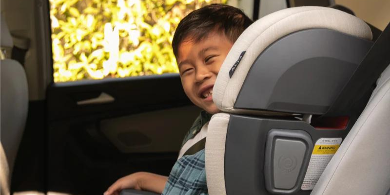 Little boy sitting in UPPAbaby Alta V2 High-Back Booster Seat