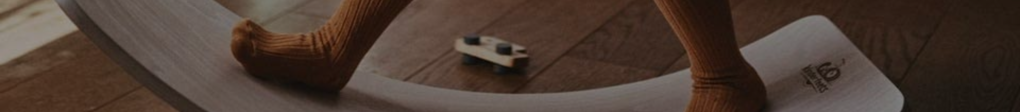 Child playing and balancing on a Kinderfeet balance board toy 