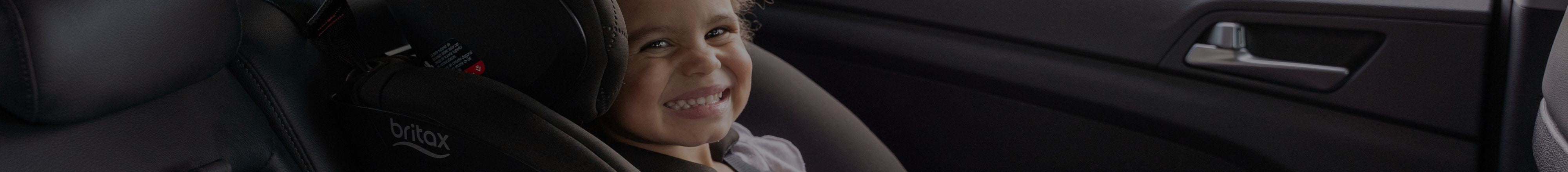 Little girl smiling & sitting in a Britax One4Life All-In-One car seat