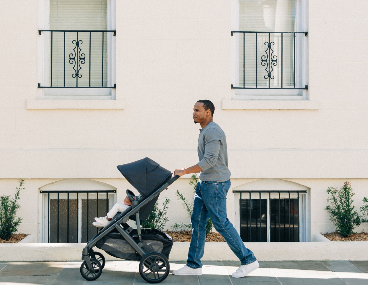 Father pushing child down the street in an UPPAbaby VISTA V2 stroller
